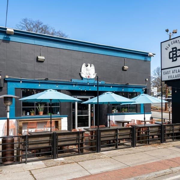 Blu Cantina restaurant exterior with black and blue facade, outdoor patio seating, and a large sign.